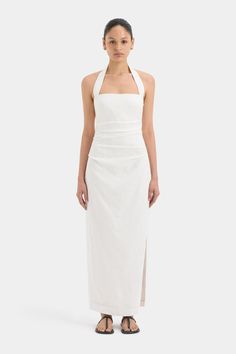 Crafted from a midweight linen fabric, offering a relaxed fitting shape, the Noemi Halter Midi Dress in ivory is the perfect warm-weather dress. Featuring a halter neck design and tucks through the body that create a flattering fit. Pair back with sandals for an elevated look. Elegant Beach Halter Dress With Gathered Neckline, Chic Linen Dress With Fitted Bodice, White Linen Midi Dress With Straight Neckline, Chic Linen Halter Neck Dress, Elegant Linen Halter Neck Dress, Fitted Linen Dress With Gathered Neckline, Chic Halter Neck Linen Maxi Dress, Elegant White Linen Dress With Straight Neckline, Elegant Linen Maxi Dress With Fitted Bodice