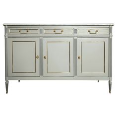 a white and gold sideboard with two doors