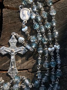 This hand made Catholic Rosary is made with Blue and white 7mm crystal blue and white beads, Silver plated heart Our Father beads, Silver plated Bead caps, stainless steel findings, Madonna centerpiece, and a silver plated grape leaf and grape catholic traditional crucifix. This Rosary is made the traditional chain Catholic way, each Bead is hand Beaded and chained, which makes the Rosary strong and very sturdy. It's made with Stainless steel findings, silver plated Findings, a traditional cente Silver Crystals 8mm Beads For Gift, Silver Crystals With 8mm Beads For Gifts, Silver Crystals With Beads For Gifts, Handmade Spiritual Blue Crystals, Handmade Silver Beaded Crystals, Handmade Silver Crystals With Round Beads, Rosary Jewelry, Rosary Beads Catholic, Vintage Jewelry Art