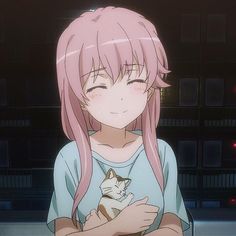 a girl with pink hair holding a cat in front of her chest and looking at the camera