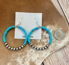 Make a statement with these stunning Turquoise Beaded Hoop Earrings. Crafted from sterling silver and finished with a Navajo Pearl accent, they're the perfect way to add a luxurious touch to your look. Add Turquoise Beaded Hoop Earrings to your jewelry collection today! Embrace the Southwest's allure with Native American Turquoise Sterling Silver Hoop earrings – a timeless addition to elevate your style for any occasion. Size: 2" inches wide x 2 3/4" inches length Stone: Turquoise with Navajo Pe Turquoise Southwestern Hoop Earrings, Turquoise Earrings With Silver Beads, Southwestern Turquoise Hoop Earrings Nickel Free, Turquoise Southwestern Nickel-free Hoop Earrings, Southwestern Turquoise Nickel-free Hoop Earrings, Deodorant Stains, Native American Turquoise, Jewelry Care Instructions, Makeup Stain