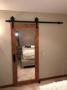 the sliding barn door is open and ready to be used as a mirror for the bedroom