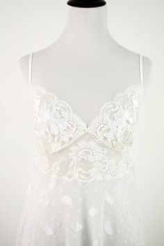 "1980s long peignoir set. White, floaty sheer polyester fabric has spots with eyelash edges. Robe has shoulder pads and lace shoulders. Stretch lace bath the waist and cuffs. Robe fastens with an inside tie and attached outside sash. Matching gown has stretchy spaghetti straps and lace bodice with appliqués. Label reads, \"Natori, Saks Fifth Avenue, Medium, made in the Philippines.\" Freshly laundered. Excellent condition. The fabric is perfectly white but the stretch lace has a bit of a yellow Sheer Lace V-neck Nightgown, Coquette Lace V-neck Nightgown, Sheer Lace V-neck Sleepwear, Summer Lace Sleepwear With Lace Trim, Sheer Lace Nightgown For Party, Sleeveless Lace Nightgown For Party, Sleeveless Party Nightgown With Delicate Lace, White Lace Fitted Nightgown, Sheer Lace Party Nightgown