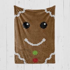 a wall hanging made to look like a gingerbread with eyes, nose and mouth