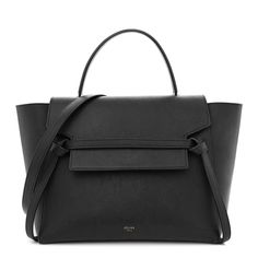 This is an authentic CELINE Grained Calfskin Mini Belt Bag in Black. This chic tote is crafted of grained calfskin leather in black with a structured and spacious silhouette. The bag features a leather top handle, optional shoulder strap with aged brass hardware, rear zipper pocket, and a front-facing flap that is secured by decorative knotted straps. The facing flap opens to a black suede interior with hanging patch pockets. Aged Brass Hardware, Mini Belt Bag, Celine Belt Bag, Aged Brass, Leather Top, Belt Bag, Black Suede, Patch Pocket, Zipper Pocket