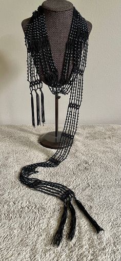 Black crochet scarf necklace approx 1.75" wide and approx 68" long made with 100% soft mercerized Egyptian cotton, 3.5" tassel fringe of polyester/rayon, and lustrous black glass beads resembling hematite. Handcrafted, sparkling accessories will brighten any woman's day.  This versatile design can be worn around the neck or hip to enhance your unique style.   Hand washing and air drying is recommended and will keep your hand made item long lasting Dress Up Any Outfit - adds sparkle to casual att Sparkling Accessories, Beaded Scarf, Spark Up, Scarf Necklace, Black Crochet, Hand Crafted Gifts, Tassel Fringe, Egyptian Cotton, Evening Attire