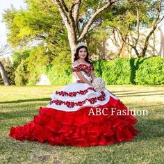 Make a statement in this off the shoulder floral ballgown with ruffled skirt by Ragazza Fashion MV17-117. Made out of tulle and floral embroidery, this beautiful charro dress features a lovely off shoulder bodice embellished with beautiful floral appliques accented with beads, long A-line skirt with voluminous ruffles, horsehair hemline, a gorgeous sweep train, and a lace-up corset back. Available Matching little girl's dress is Ragazza Fashion Style N14-714. Designer: Ragazza Fashion Morena y E Charro Dress, Floral Ballgown, Quinceanera Dresses Mexican, Quince Dresses Charro, Vestido Charro, Charro Quince, Red And White Outfits, Mexican Quinceanera Dresses, Quinceanera Themes Dresses