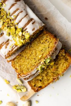 three slices of cake with white frosting and pistachio sprinkles