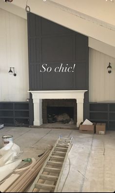 an empty room with a fireplace in the middle and signs on the wall above it that say so chic