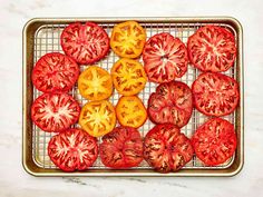 sliced tomatoes on a baking sheet ready to be cooked in the oven for roasting