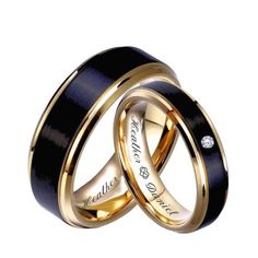 two wedding rings with black and gold inlays, one has a diamond on the inside