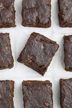 chocolate brownies arranged in rows on top of each other with one bite taken out