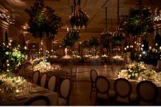 an elegant ballroom with chandeliers and tables set up for formal dinnereons