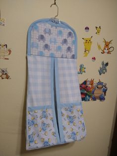 a blue and white towel hanging on the wall next to a baby's crib