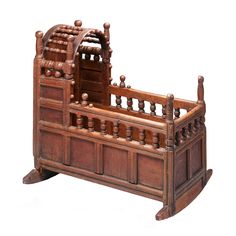 an old wooden bed frame with carvings on the top and bottom sides, in front of a white background