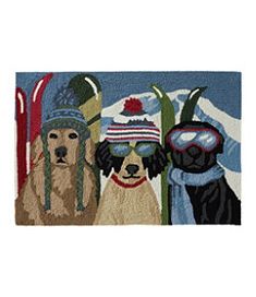 three dogs wearing skis and goggles on a rug