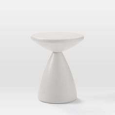 a small white table sitting on top of a white floor