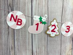 christmas decorations hanging on a wooden fence with the number one, two and three decorated cookies