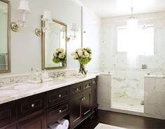 a bathroom with two sinks and mirrors in it