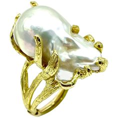 A wonderful Tanya Farah Pearl fashion ring. The 28.50mm x 15.40mm baroque pearl is set in textured sea grass 18k yellow gold, with a split shank. The Pearl has tremendous luster and sheen to it. The ring is currently a size 6.50, and can be sized as needed. Offered by Charles Schwartz and Son Jewelers. Luxury Elegant Baroque Pearl Rings, Luxury Heirloom Pearl Ring, Luxury Handmade Yellow Gold Pearl Ring, Bridal Pearl Necklace, Mikimoto Pearls, Pearl Jewelry Wedding, Pearl Necklace Set, Gold Rings Fashion, Jewelry Pearl