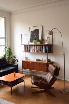 a living room filled with furniture and a book shelf on top of a hard wood floor