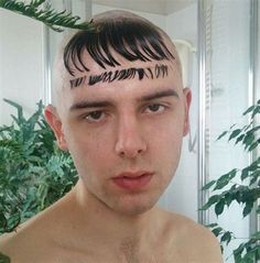 a young man with his hair cut into the shape of letters on his forehead and undercuts