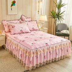 a bed with pink bedspread and matching pillows