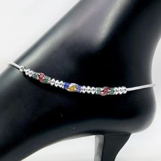 Beautiful Pair of anklets in silver. They have been adorned with small bells that make a beautiful noise. They are available in a few different sizes. Fits and sits like a curve on the ankles. Best for gifting or for personal use, wear it to any occasion and be the spotlight. Feel free to contact us at any time. We will try to promise you amazing shopping experience. Eye-catching and unique jewelry that will set you apart. Gift this piece to a loved one, and see their face light up with joy. Twi Adjustable Metal Anklets For Festivals, Adjustable Silver Anklets For Festivals, Silver Beaded Anklets For Festival, Silver Beaded Toe Ring Anklets, Silver Beaded Festival Anklets, Festive Metal Anklet With Silver Beads, Festival Silver Beaded Anklets, Traditional Silver Beaded Anklets, Adjustable Metal Anklet For Festive Occasion