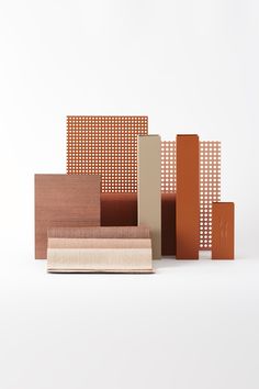 an assortment of different types of tiles on a white surface, including orange and brown