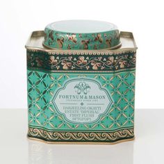 a teal tin with gold trimming and a label that says fortnum & mason