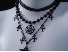 Unveil your dark, mystical allure with our Black Gothic Triple Layered Necklace. The necklace boasts a sophisticated triple-layered design, each chain meticulously crafted to fall at different lengths. The second layer is adorned with a prominent hexagram pendant. Complementing the hexagram, the third layer features cross pendants, embodying gothic influences. Black Gothic Clavicle Chain Necklace, Gothic Black Clavicle Chain Necklace, Black Gothic Chain Necklace Gift, Black Mystical Choker Necklace, Mystical Black Choker Necklace, Mystical Style Black Choker Jewelry, Mystical Black Jewelry For Party, Black Gothic Necklace With Chain, Black Handmade Necklace For Layering