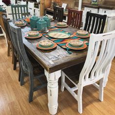 a wooden table topped with lots of plates