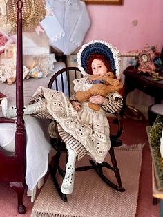 a doll is sitting in a rocking chair