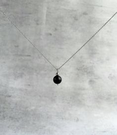 "Shungite pendant necklace for women - executes an effortlessly elegant hint of sparkle to any outfit.  Explore ways to layer this piece or wear it on its own for a minimal look. Dainty, minimal, stylish necklace. Great gift idea for women (wife, girlfriend, mom, sister...). Necklace length: 36 cm (14\") + 5cm (2\") chain extension.  Please email me for a longer or shorter size of the necklace. Shungite bead - 10 mm. Shungite: * protects one against the draining/stealing of vibrational energy fr Minimalist Everyday Necklace With Gemstone Beads, Minimalist Beaded Necklace With Pearl Pendant For Gift, Minimalist Silver Necklace With Gemstone Beads, Black Sterling Silver Choker Necklace, Everyday Black Round Pendant Necklace, Minimalist Gemstone Beads Necklace As Gift, Black Round Pendant Necklace For Everyday, Minimalist Gemstone Beads Necklace For Meditation, Minimalist Black Round Beaded Necklaces