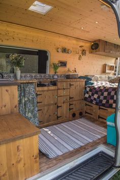 the inside of a camper with wood cabinets and drawers