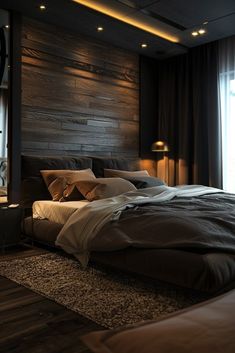 a large bed sitting next to a window in a room with wooden walls and flooring