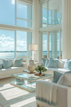 a living room filled with lots of windows next to a white couch and coffee table