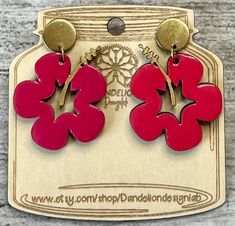 the earrings are red and gold with two hearts on each earring, one is shaped like a flower