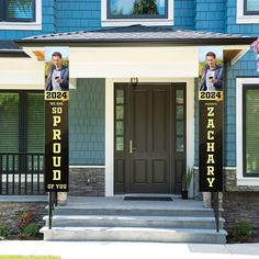 two men standing in front of a blue house with black and yellow signs on it