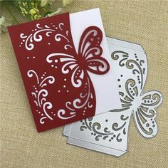 two red and white greeting cards with butterfly dieing on them, one in the shape of a heart