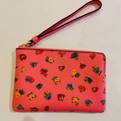 Coach Corner Zip Wristlet/ Mini Vintage Rose Print/Pink/Multi Leather New With Tags Printed Coated Canvas And Smooth Leather Two Credit Card Slots Zip-Top Closure, Fabric Lining Wrist Strap Attached 6 1/4" (L) X 4" (H) X 1/2" (W) Style No. Ca716 Gold Foil Logo Gold-Tone Hardware Wrist Strap: 7" In Length Msrp $78.00 Imported Pink Clutch Wristlet As A Gift, Pink Clutch Wristlet, Trendy Pink Coach Wallet, Trendy Pink Wristlet For Spring, Elegant Pink Coach Clutch, Pink Clutch With Wrist Strap, Pink Pouch Wristlet With Wrist Strap, Pink Pouch Wristlet With Strap, Pink Pouch Clutch With Wrist Strap