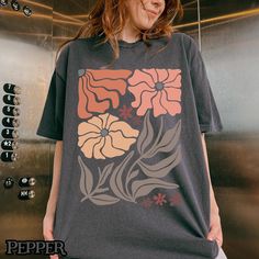 Celebrate your love for nature with this enchanting wildflowers t-shirt, designed for the true botanical enthusiast. Featuring a Matisse-inspired floral design, this tee perfectly blends the charm of cottagecore with a touch of boho style. Ideal as a thoughtful gift for her , this shirt is perfect for plant moms, nature lovers, and anyone who appreciates the beauty of wildflowers. Whether you're exploring the outdoors, enjoying a cozy day in, or showcasing your love for all things botanical, thi Relaxed Fit T-shirt With Plants Print, Nature-inspired Summer T-shirt With Plant Print, Nature-inspired T-shirt With Plants Print For Summer, Botanical Flower Graphic Print T-shirt, Botanical Style Flower Graphic T-shirt, Flower Graphic Print Botanical Tops, Botanical Flower Graphic Print Tops, Nature-inspired Graphic Print T-shirt For Spring, Botanical Style Flower Graphic Print Tops