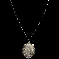 Grace and beauty abound in this simple, yet powerful our Art Nouveau Madonna medallion that has been hand cast from the vintage original dating from approximately 1906. She hangs from 36" of Black Jet beads and is long enough to wear double wrapped. A decorative toggle provides a beautiful effect. The image of the Assumption of the Blessed Virgin was hand carved based upon the painting by Spanish artist Bartolome Esteban Murillo (1618 - 1682). The image is captivating and Her face on the medalli Black Spiritual Jewelry With Antique Finish, Black Medallion Locket Necklace, Memorial Medallion Necklace With Antique Finish, Black Medallion Necklace With Vintage Charm, Vintage Black Medallion Necklace, Garnet Necklace Gold, Trinity Necklace, St Christopher Medal, Angel Bracelet