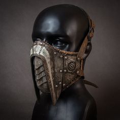 Leather and steel mask. Inside the mask is leather, base is hand-stitched and trimmed with leather at the edges. Metal elements are hand-cut from steel and then shaped using repoussage techniques. The whole is carefully painted, shaded and chemically and mechanically aged.  Adjustable - It ties up with leather buckles.  It will fit more on a male face (due to the size of the mask), but on request I can make a smaller version that will fit a smaller face. The mask is a prop, it is not a real dust Warrior Style Masks And Prosthetics For Larp And Halloween, Gothic Leather Masks And Prosthetics For Costume, Gothic Leather Masks For Costumes, Medieval Mask For Larp, Adjustable Post-apocalyptic Mask, Warrior Style Masks And Prosthetics For Halloween, Gothic Leather Masks And Prosthetics For Cosplay, Warrior Style Masks For Cosplay And Masquerade Events, Post-apocalyptic Festival Mask