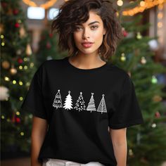 Celebrate the holiday season in style with our adorable Christmas Trees Shirt! This cute Christmas shirt is perfect for family gatherings, Christmas parties, and festive outings. Made from soft, comfortable fabric, it can double as your favorite Christmas sweatshirt or crewneck, making it a versatile addition to your Christmas outfit collection. Looking for the ideal Christmas gift for a loved one? This charming Christmas tree tee will surely bring joy and smiles! Whether you're dressing up for Casual Festive Tops For New Year, Casual New Year Tops, Black Casual T-shirt For Festive Occasions, Casual Holiday Tops For New Year, Casual Black T-shirt For Festive Occasions, Casual Black Tops For New Year, Black Top As Christmas Gift, Casual Festive Tops For Christmas, Black Short Sleeve T-shirt For Festive Occasions