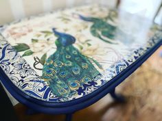 a blue and white table with a peacock design on it