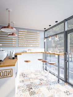 a kitchen with tiled flooring and bar stools next to the counter top area