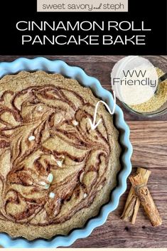 cinnamon roll pancake bake on a wooden table with cinnamon sticks and cinnamon stick