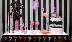 a table topped with lots of pink flamingos