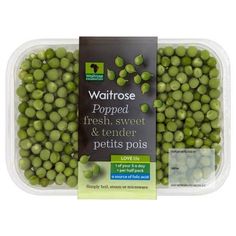 green peas in a plastic container with a label on the top and bottom half of it